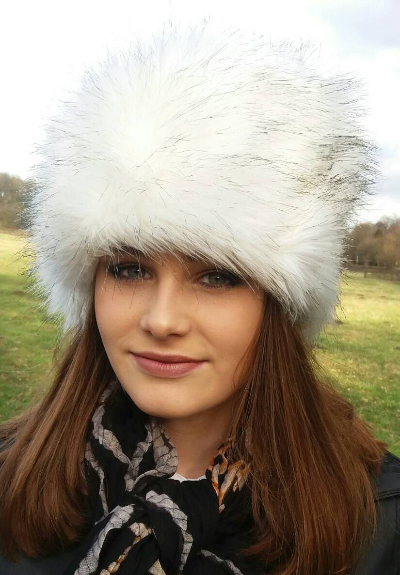 beautifu faux fur hat which is white with black tips worn outside